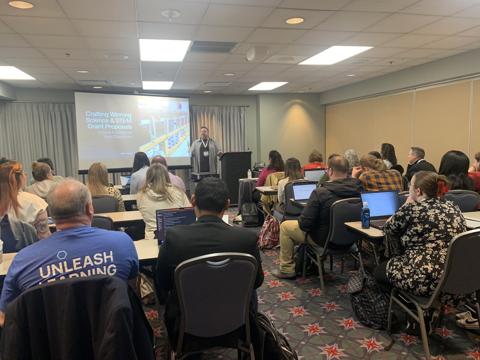 Kevin Welch speaking to a room of educators at a conference